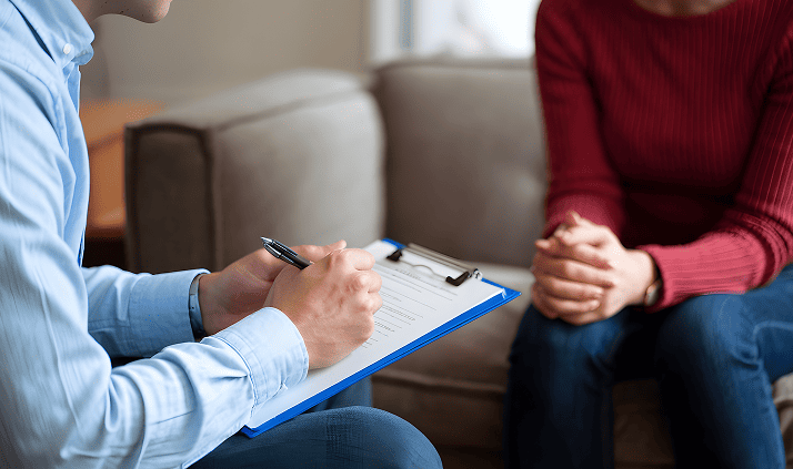 man-is-writing-piece-paper-with-pen-woman-sitting-him